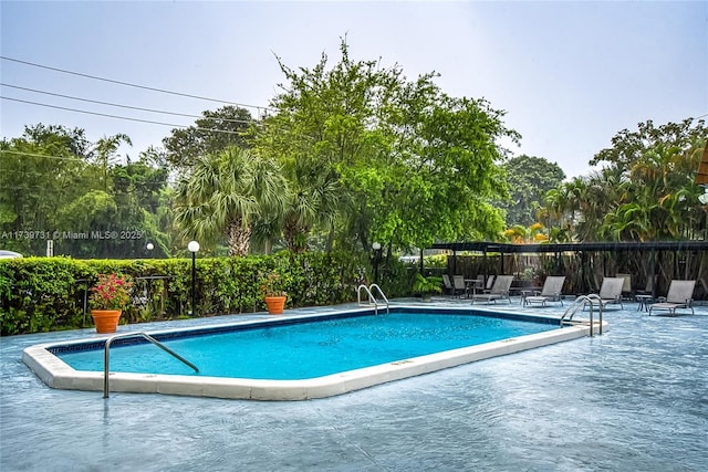 view of swimming pool featuring a patio area