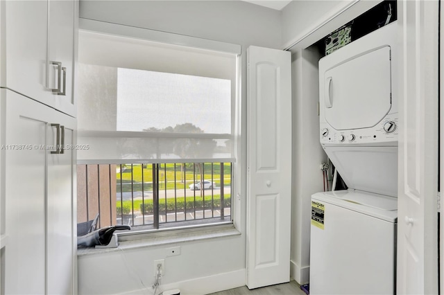 laundry area with stacked washer / dryer