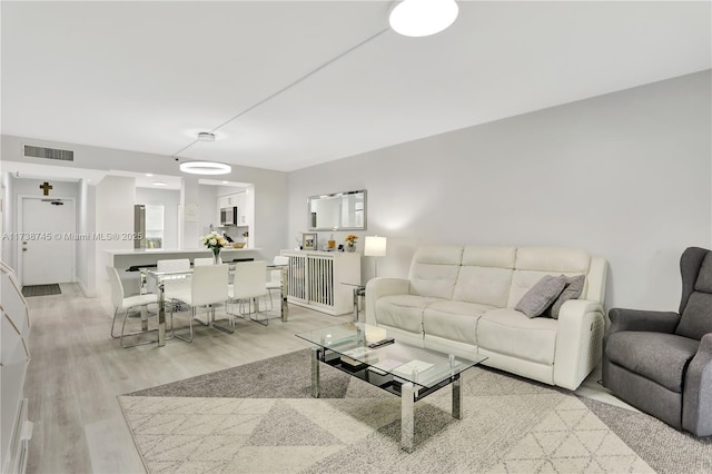 living room with light hardwood / wood-style flooring