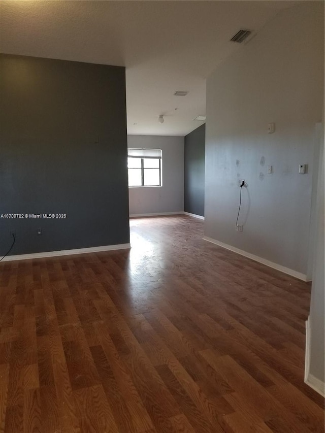 spare room featuring dark hardwood / wood-style floors