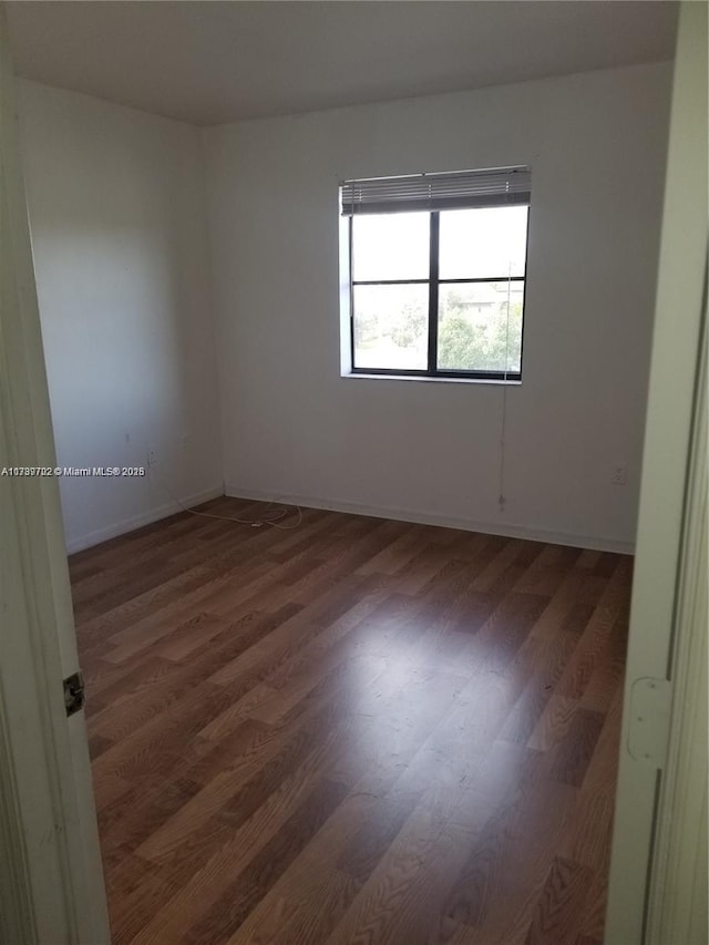 empty room with dark hardwood / wood-style floors