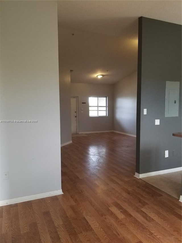 spare room with wood-type flooring and electric panel