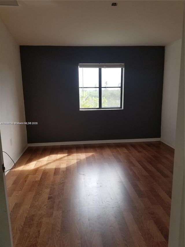 spare room featuring hardwood / wood-style flooring