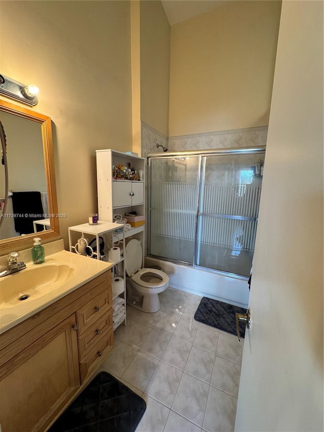 full bathroom featuring enclosed tub / shower combo, tile patterned floors, toilet, and vanity