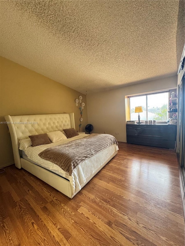 bedroom featuring wood-type flooring and a textured ceiling