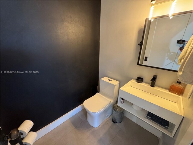 bathroom with tile patterned floors and toilet