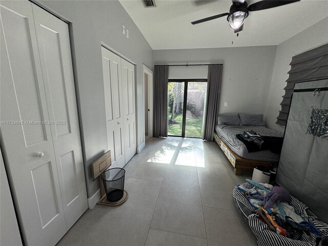 tiled bedroom featuring ceiling fan and access to exterior