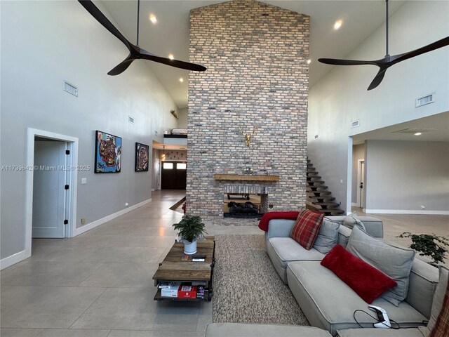 living room with a fireplace and ceiling fan