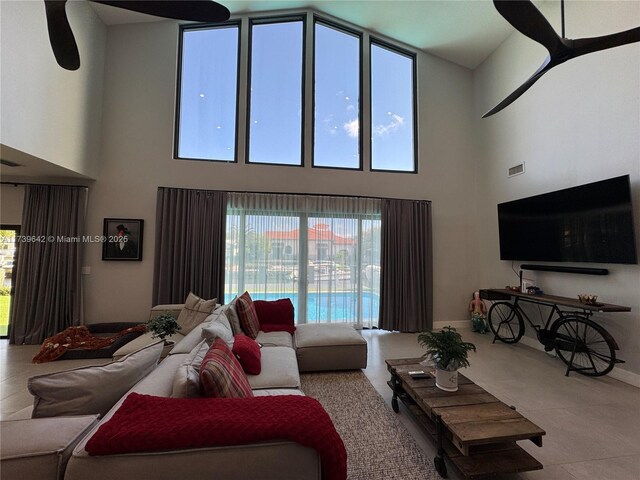 living room featuring a high ceiling and a wealth of natural light