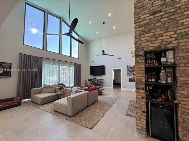 living room featuring light tile patterned floors, a towering ceiling, and ceiling fan