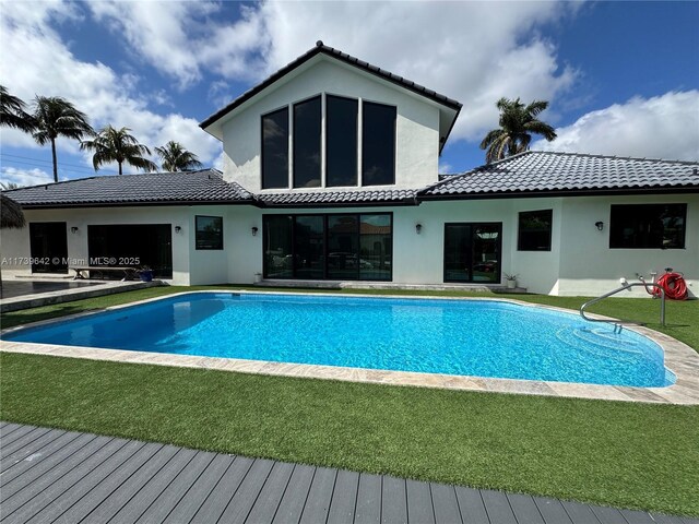 view of swimming pool featuring a yard and a patio