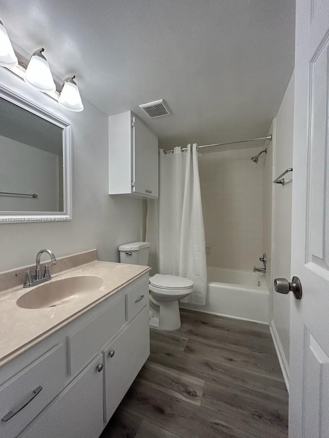 full bathroom featuring vanity, wood-type flooring, toilet, and shower / bath combo