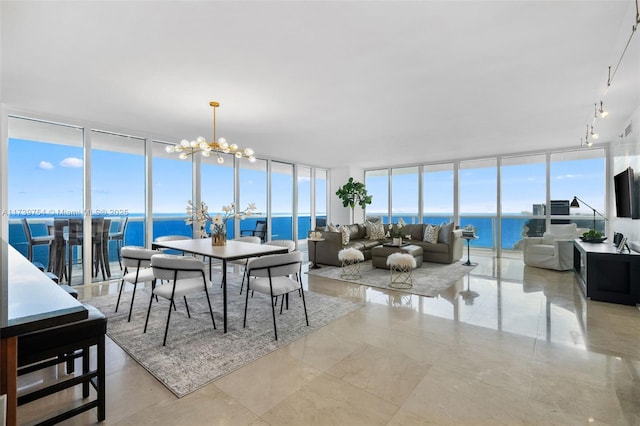 dining room featuring plenty of natural light, floor to ceiling windows, and a chandelier