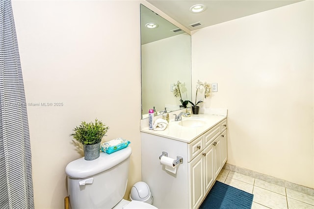 bathroom featuring tile patterned floors, toilet, and vanity