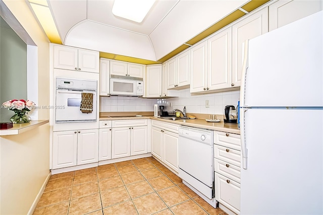 kitchen featuring white cabinetry, white appliances, and tasteful backsplash