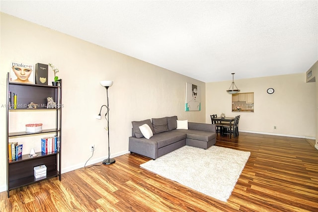 living room featuring hardwood / wood-style floors and a textured ceiling