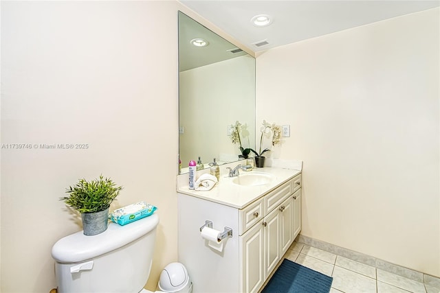 bathroom with tile patterned flooring, vanity, and toilet