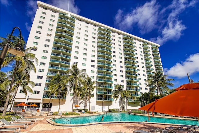 view of building exterior with a community pool