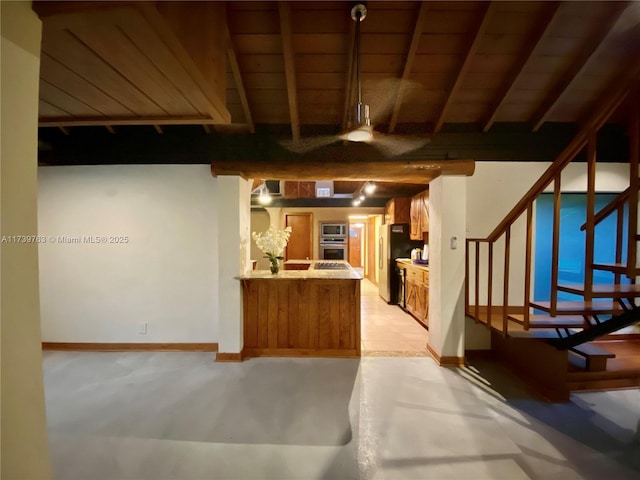 kitchen with beamed ceiling, appliances with stainless steel finishes, wooden ceiling, and kitchen peninsula