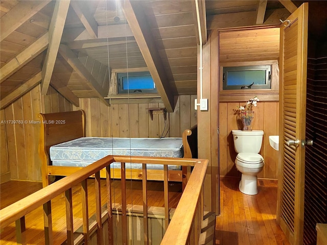 interior space featuring hardwood / wood-style flooring, wood ceiling, wooden walls, and lofted ceiling with beams