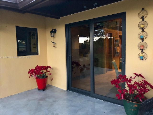 doorway to property with a patio area