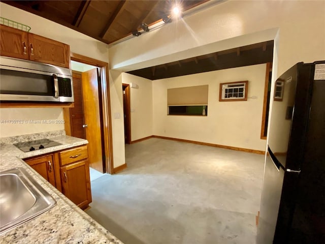 kitchen featuring vaulted ceiling with beams, wood ceiling, sink, and black appliances