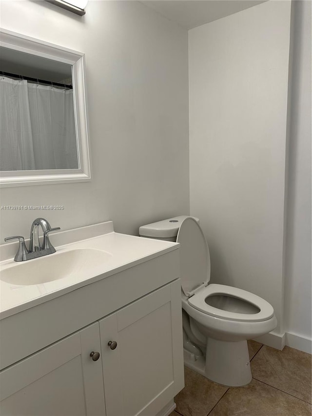 bathroom with vanity, tile patterned floors, and toilet