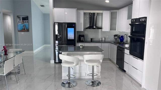 kitchen with sink, white cabinetry, a kitchen breakfast bar, black appliances, and wall chimney exhaust hood