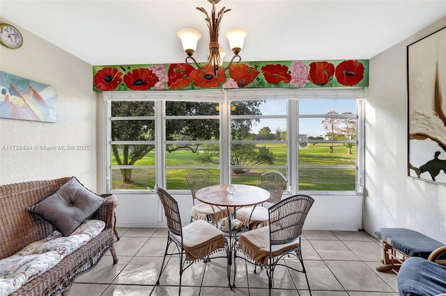 sunroom / solarium featuring a chandelier