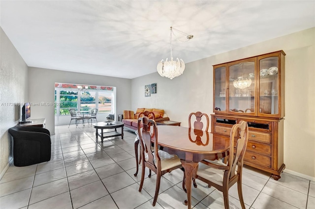 dining area featuring an inviting chandelier and light tile patterned flooring