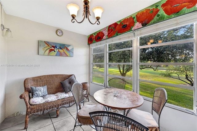 sunroom / solarium with a chandelier