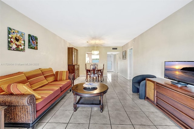 tiled living room with a chandelier