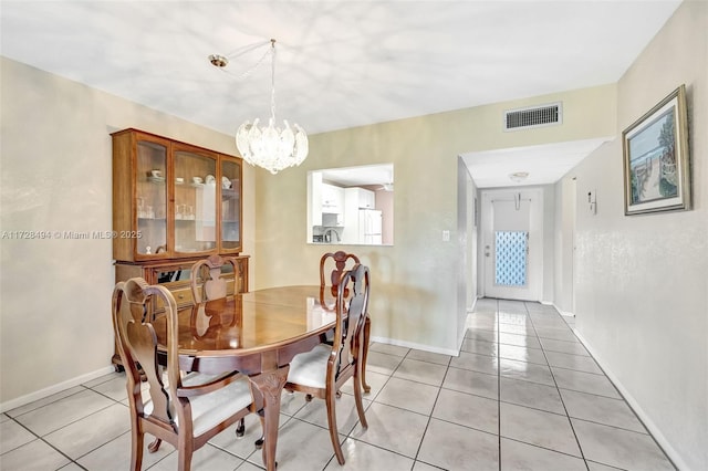 dining room featuring an inviting chandelier and light tile patterned flooring