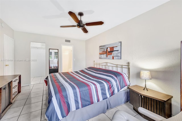 tiled bedroom with ceiling fan and ensuite bathroom