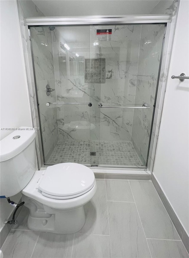 bathroom with toilet and an enclosed shower