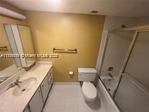 full bathroom with shower / bath combination with glass door, vanity, and toilet