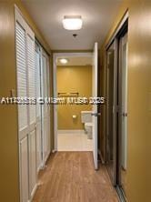 hallway with light hardwood / wood-style floors