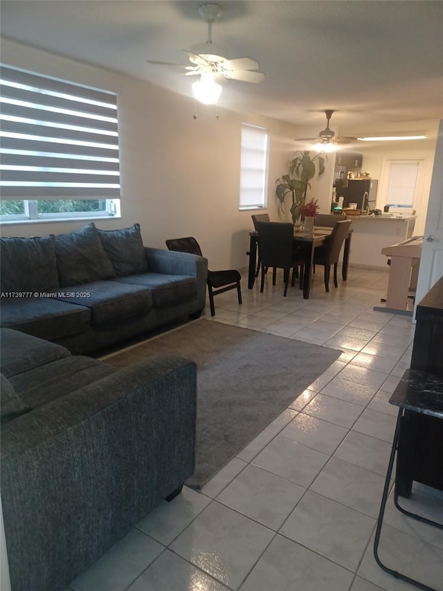 tiled living room with ceiling fan