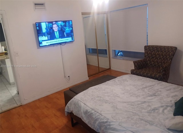 bedroom with hardwood / wood-style flooring and a closet