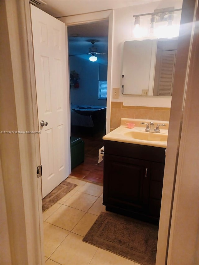 bathroom with tasteful backsplash, ceiling fan, tile patterned floors, and vanity