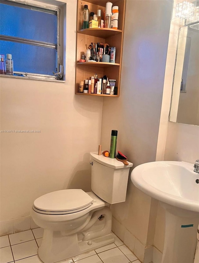 bathroom with tile patterned floors and toilet