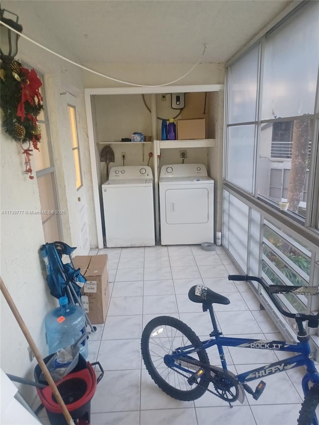 laundry area with separate washer and dryer and light tile patterned floors