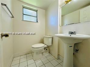 bathroom featuring tile patterned flooring, sink, and toilet