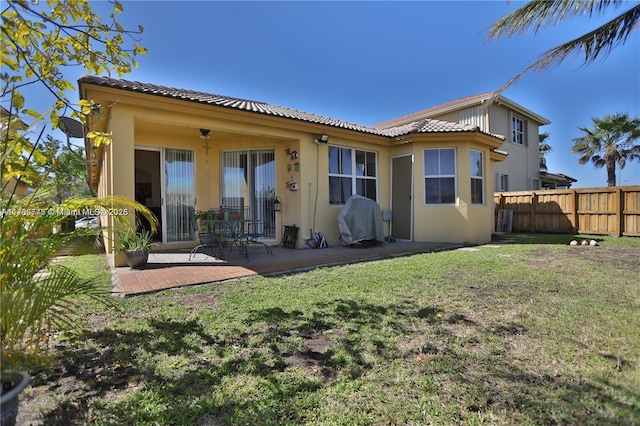 back of property featuring a yard and a patio area