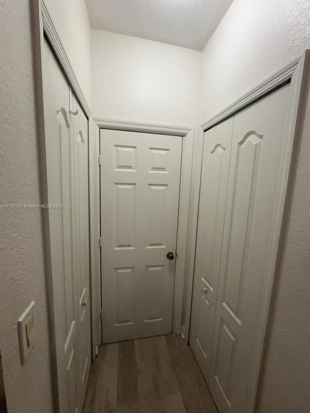 hallway with dark hardwood / wood-style floors