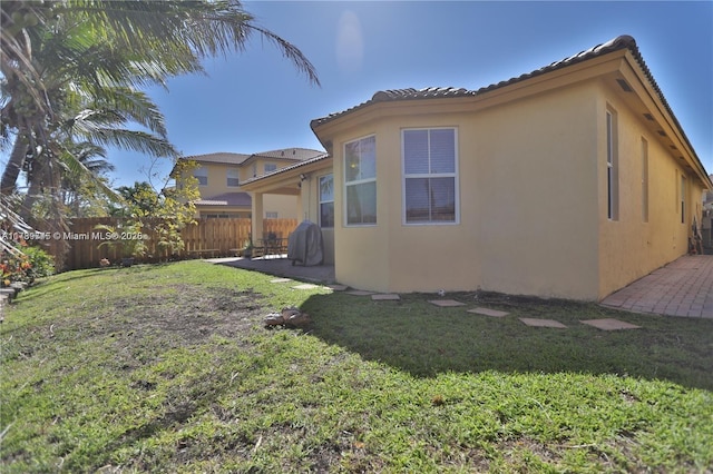 rear view of property featuring a yard