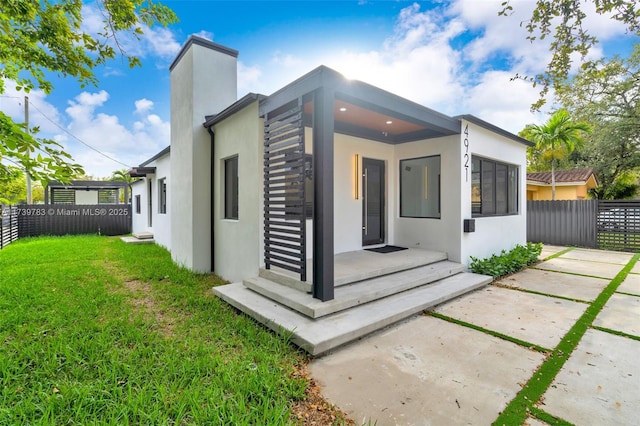 rear view of property featuring a yard