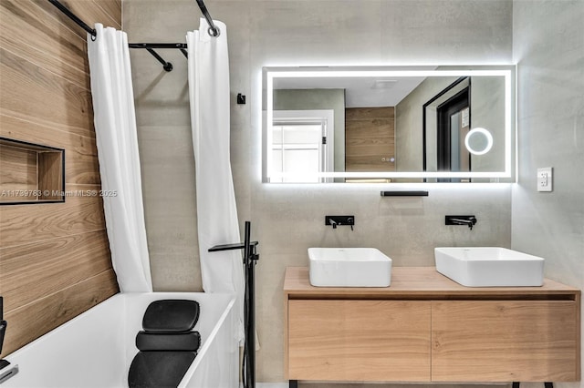 bathroom featuring shower / bathtub combination with curtain and vanity