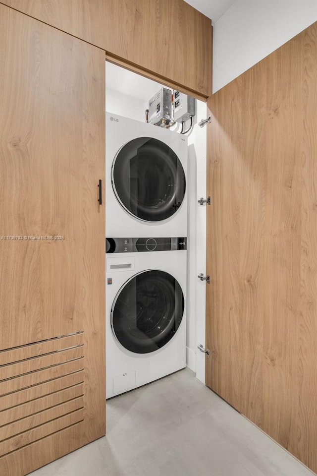 laundry room featuring stacked washer / drying machine