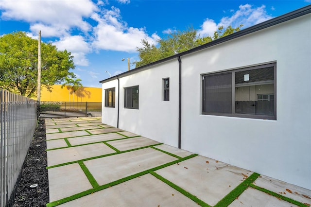 property exterior at dusk with a patio area